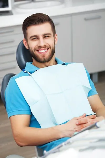 man smiling in the dental chair at Evergreen Smile Studio