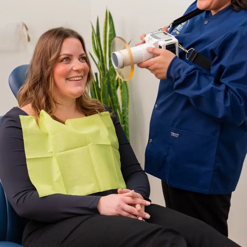 team member taking dental photos of a patient in Seattle, WA